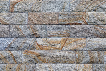 Old stone masonry wall covered with moss mountain gray.