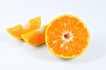 Half and slice of orange on white background.