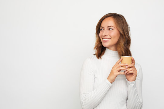 Portrait Of Happy Young Woman With To Go Cup Of Coffee