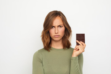portrait of young woman with chocolate mad and sad