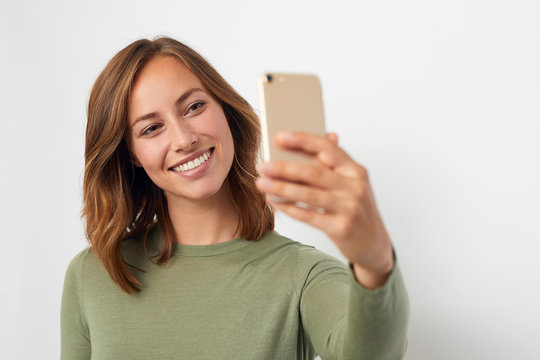 young smiling woman taking a selfie 
