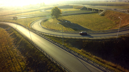Aerial Top View of highway intersection junction summer morning with car