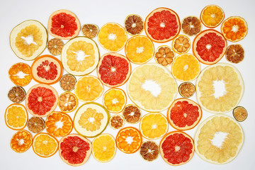 mix of different pieces of dried citrus fruit on white background