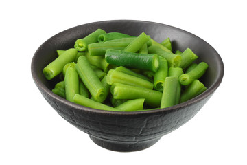 cut green beans in wooden bowl isolated on white background.