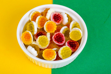 Sweet colored jelly candies on white plate