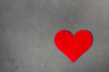 Red paper heart on gray wall with copy space Happy Valentine background