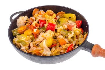 Frying pan with steamed vegetables isolated on white background