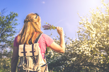 Welcome spring. Happy caucasian woman is enjoying spring in blooming orchard. Woman feeling free. Toned picture