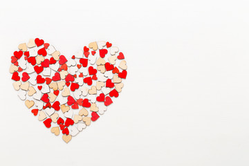 Valentines day background red hearts on white wooden background.