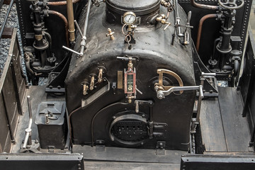 Old vintage steam locomotive cabin. Controls of a vintage steam locomotive, boiler and gauges.