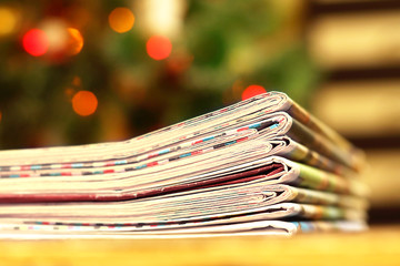 Pile of fresh morning newspapers on the table at office. Latest financial and business news in...
