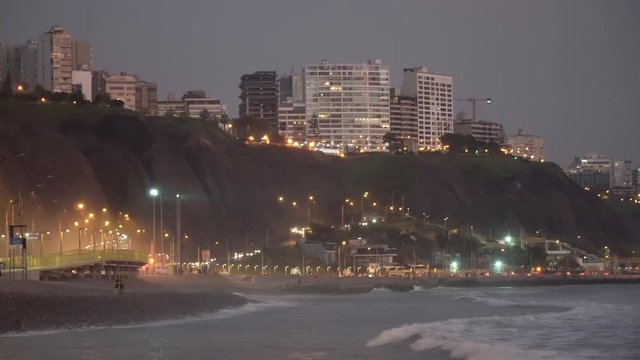 Nightfall over sea, highway and buildings in Malec&radic;&ge;n de Miraflores, Lima Per&radic;&int;. View from sea.