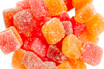 Red, yellow and orange jelly candies shot close up on a white background