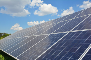 Obraz premium View on solar panels surface background with beautiful clouds sky