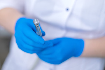 Dental drill in the hands of the dentist