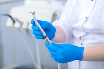 Dental drill in the hands of the dentist