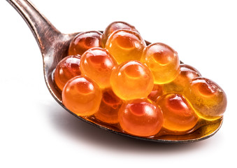 Silver spoon of red caviar on white background. Macro picture.