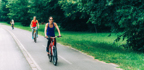 Fototapeta premium Women Riding Bicycles Together