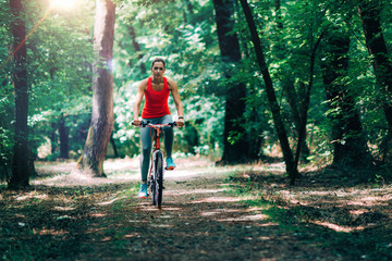 Obraz premium Woman Cycling in a Park