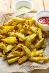 Healthy oven baked French fries with turmeric and curry spices
