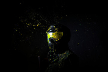  Paintball Mask zoomed in on.Splashes after direct hit to protecting mask in the paintball game.the photo as a paintball sphere is broken off at blow about a helmet.direct hit (paintball game)