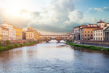 Fototapeta na wymiar Firenze landmarks. View of stone bridge Ponte Vecchio and the Arno River from the Ponte Santa Trinita (Holy Trinity Bridge) in Florence, Tuscany, Italy