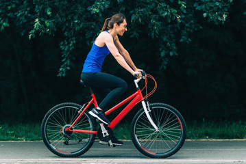 Fototapeta premium Woman Cycling in a Park