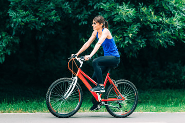 Plakat Woman Cycling in a Park