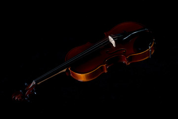 Violin music instrument of orchestra closeup isolated on black.Violin isolated on black. Classical music instruments of orchestra Violin with bow
