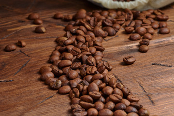 coffee beans on a wooden background scattered