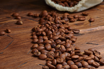 coffee beans on a wooden background scattered