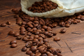coffee beans on a wooden background scattered