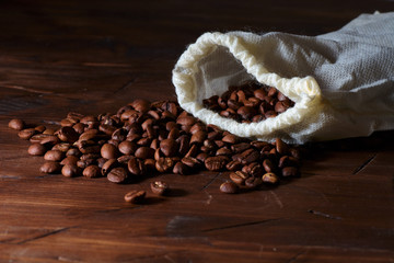 coffee beans on a wooden background scattered