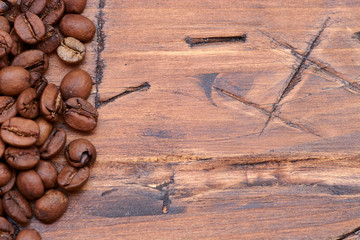 coffee beans on a wooden background scattered