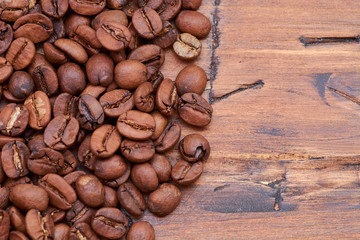 coffee beans on a wooden background scattered