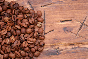 coffee beans on a wooden background scattered