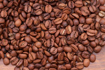 coffee beans on a wooden background scattered