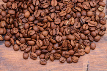 coffee beans on a wooden background scattered