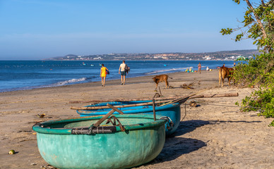 SAIGON, VIETNAM - JANUARY 18, 2019: Unidentified tourists are traveling fishing village and looking for a Vietnamese fishing boat at the village, Binh Thuan, South of Vietnam.
