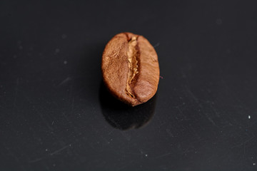coffee beans on black background consistent with