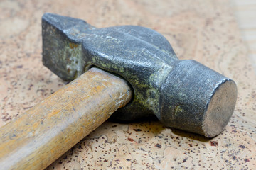Old vintage hammer on cork background. Close up