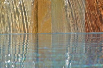Zoom on a small waterfall from a Swimming pool