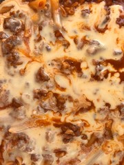 Top view of baked Stuffed macaroni with Tomato and bechamel Sauce to Bolognese-style