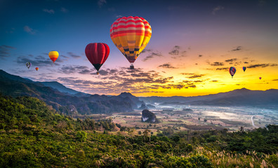 Colorful hot air balloons flying over mountain at Phu Langka national park, Phayao province in Thailand