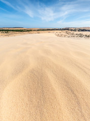 White sand dunes and blue sky background in Mui Ne , South of Vietnam