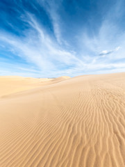 White sand dunes and blue sky background in Mui Ne , South of Vietnam