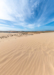 Fototapeta na wymiar White sand dunes and blue sky background in Mui Ne , South of Vietnam