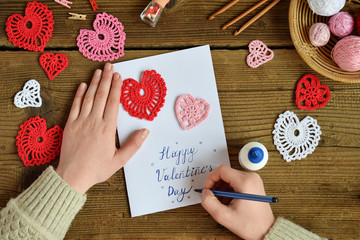 Making of handmade Valentine greeting card with crochet openwork hearts. Making of handmade...