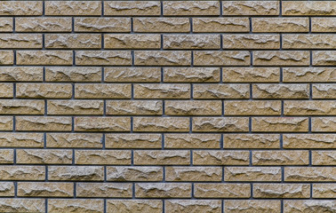 Brick wall with a contrast pattern with a broken stone background texture