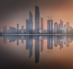 Cityscape of Abu Dhabi Skyline at misty sunrise, UAE